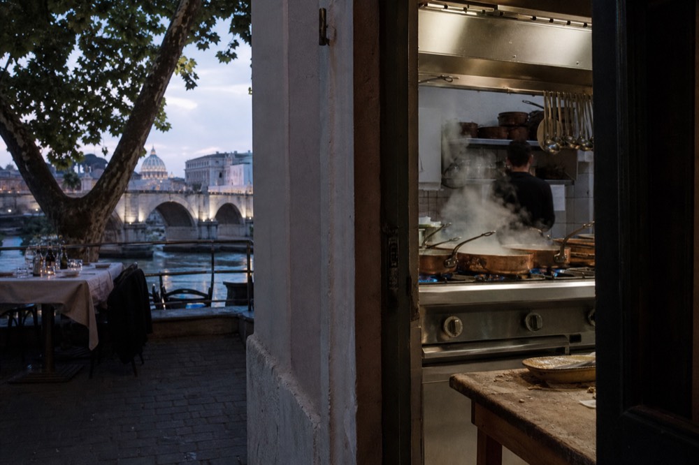 A Roman kitchen at the start of the evening service, pans on the flame