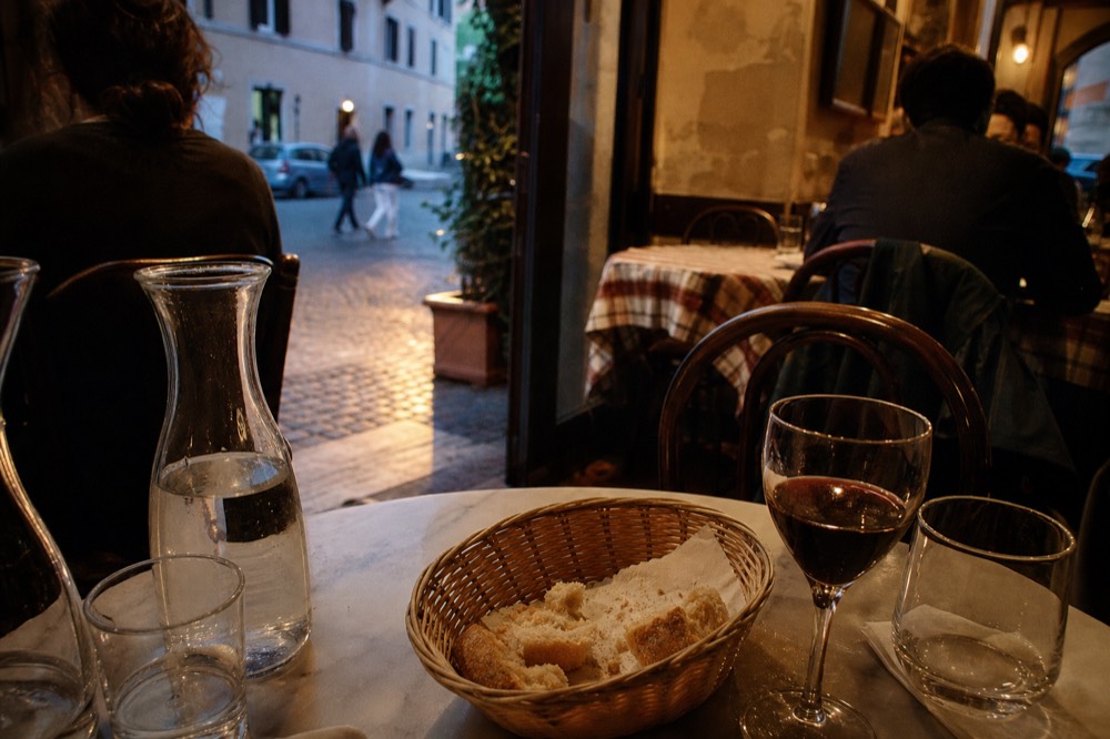 Busy Roman trattoria interior with tables and chairs